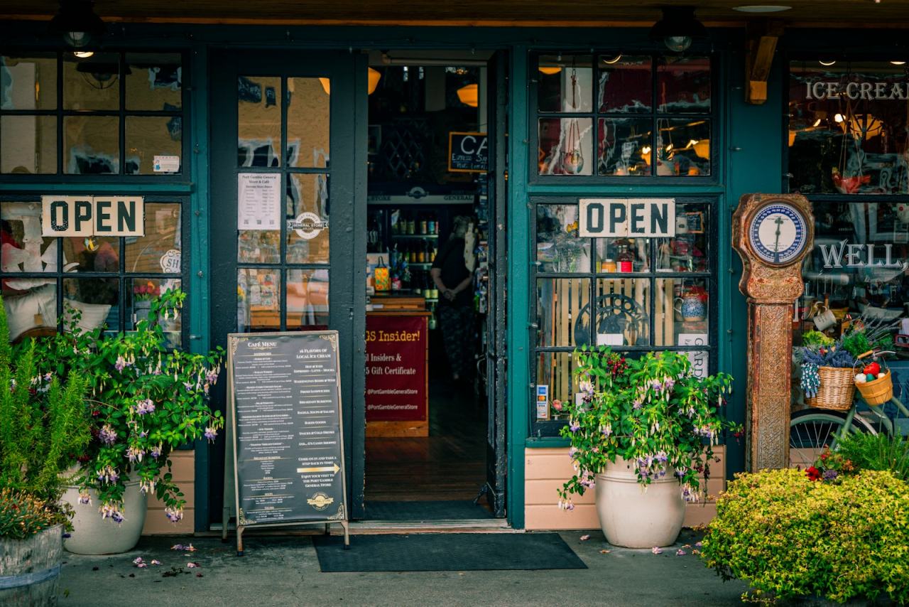 Independent shopfront with open signs and plants